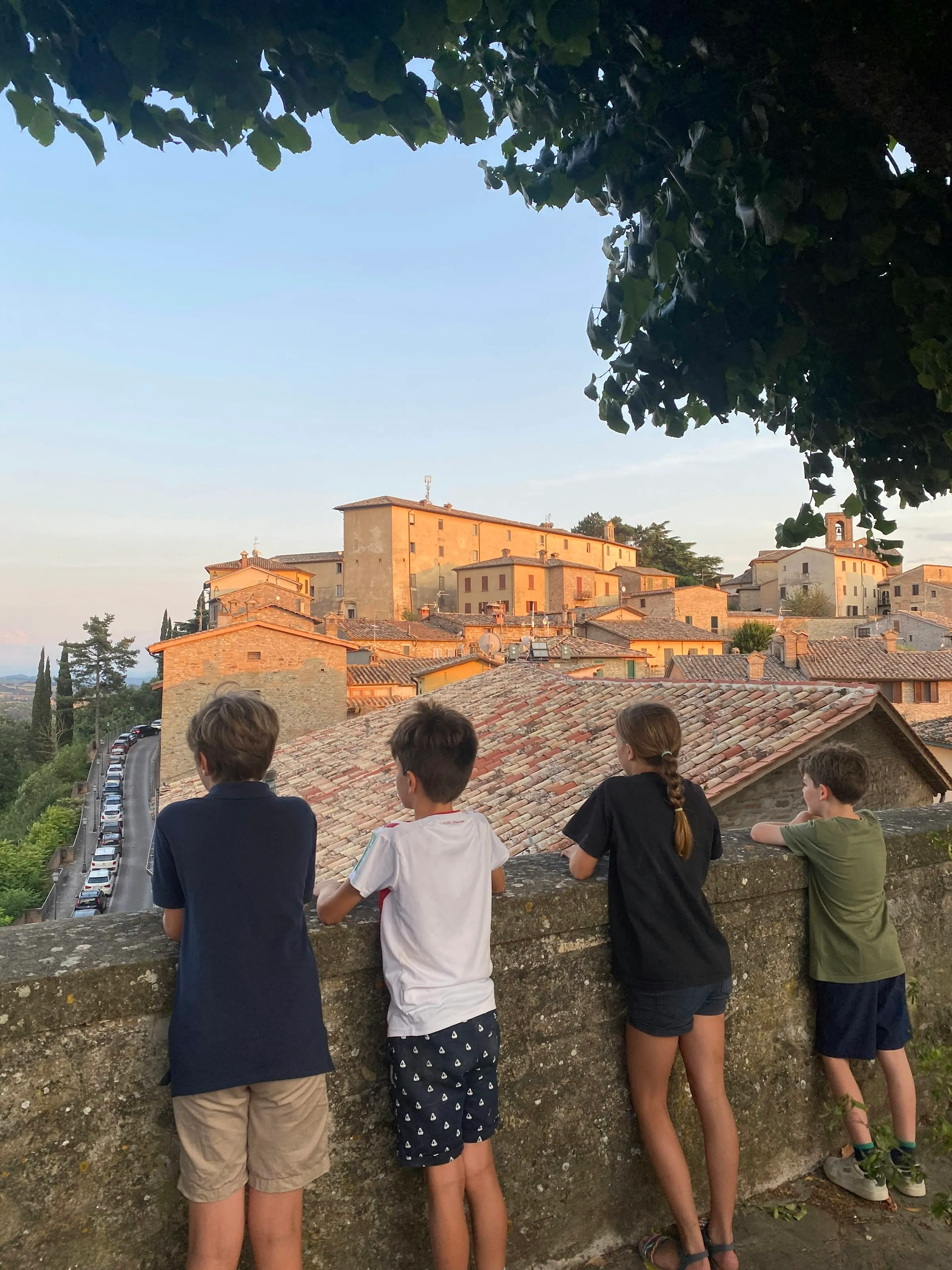 Kinder stehen an einer Stadtmauer